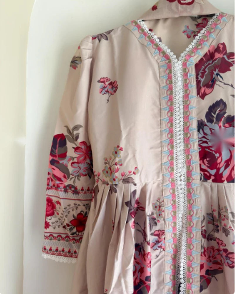Close-up of lace V-neck and embroidered sleeve on beige floral silk kurti
