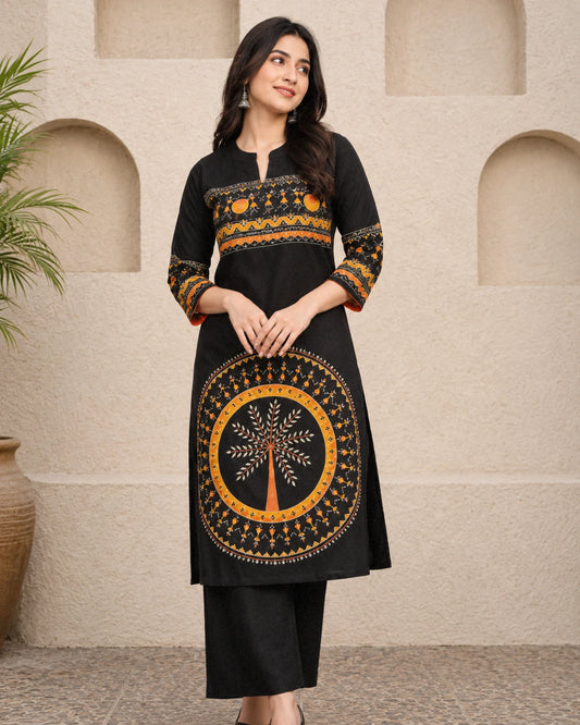 Woman wearing black block print cotton kurta with orange tree of life motif and folk art yoke