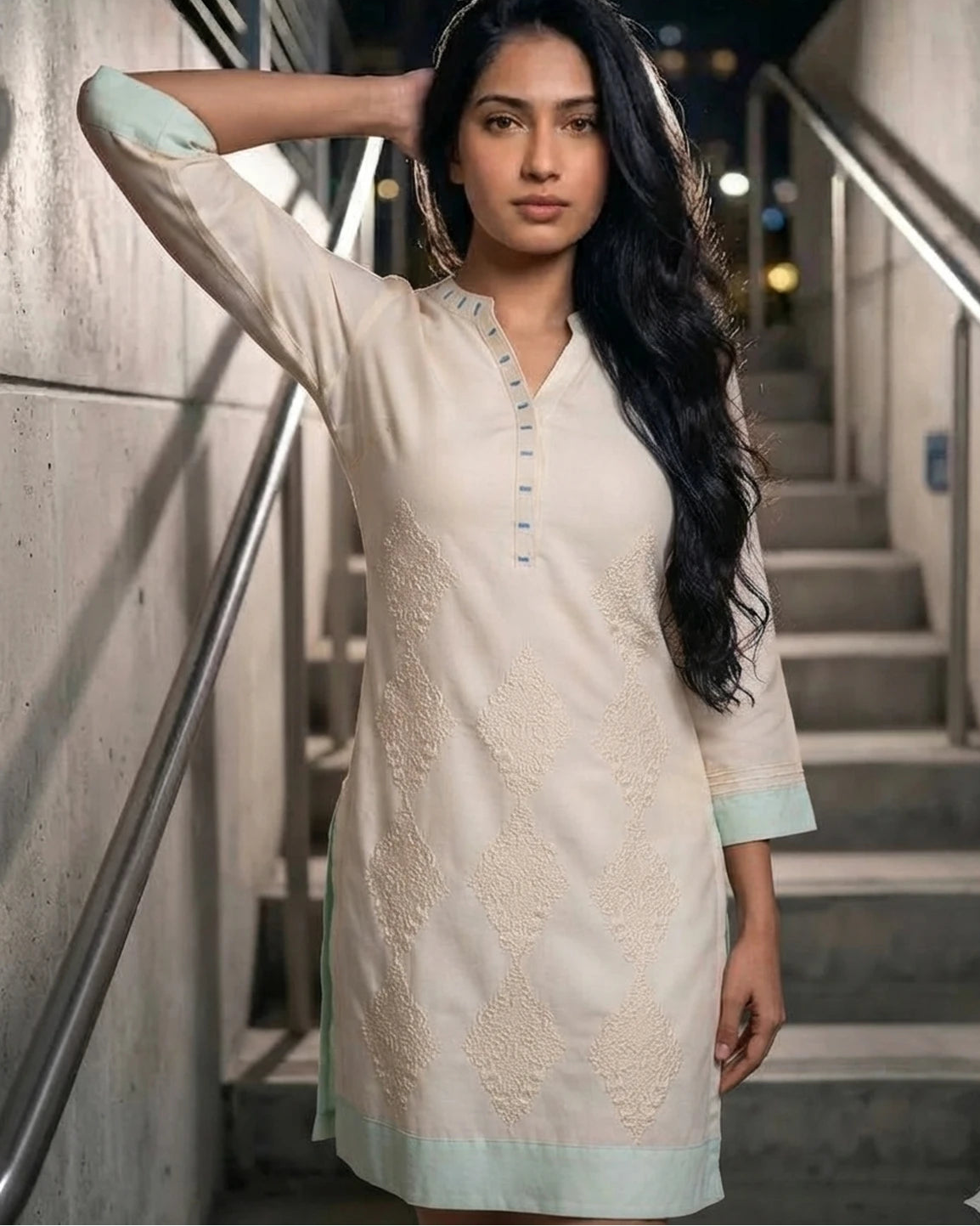 Woman wearing ivory embroidered cotton kurta, front pose