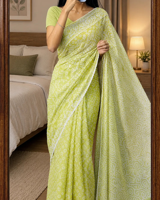 Woman in lime green batik print saree, mirror selfie bedroom styling