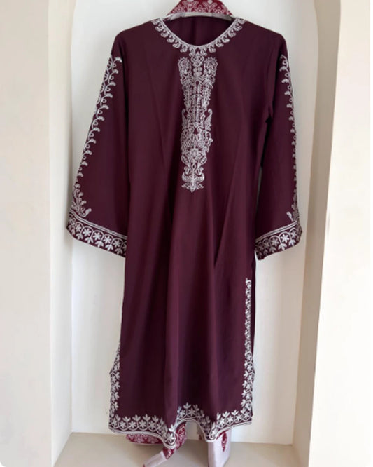 Maroon embroidered cotton kurti on hanger showing neckline, sleeve and hem embroidery