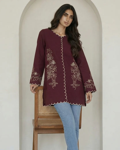 Woman wearing maroon floral embroidered microcrepe one piece, standing pose