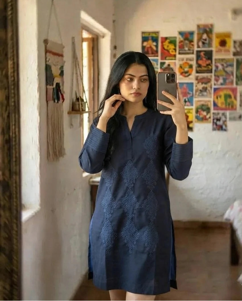 Woman wearing navy blue embroidered cotton kurta, front pose