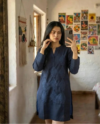 Woman wearing navy blue embroidered cotton kurta, front pose