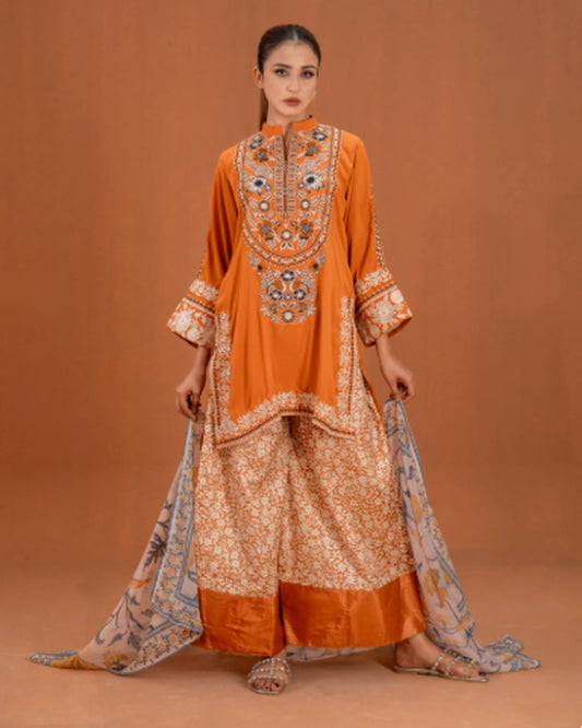 Woman wearing orange embroidered 3pc suit with printed palazzo and dupatta, front pose