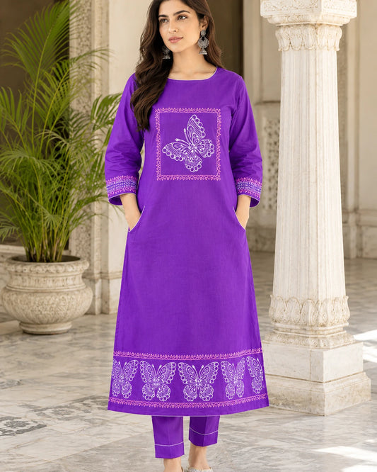 Woman wearing purple butterfly block print cotton kurta with matching pants, front view