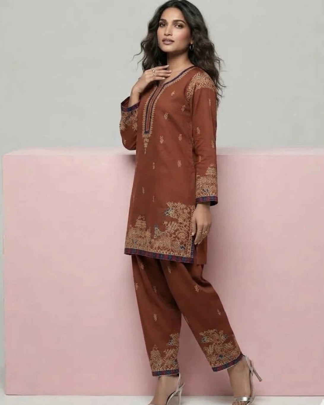 Woman wearing rust brown embroidered 2pc suit, side pose
