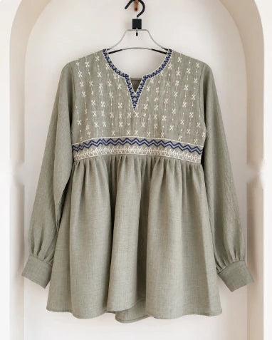 Sage green embroidered cotton peplum kurti with blue and white yoke embroidery, on hanger
