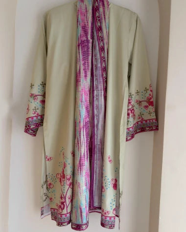 Sage green silk three piece suit with tie-dye dupatta draped, on hanger