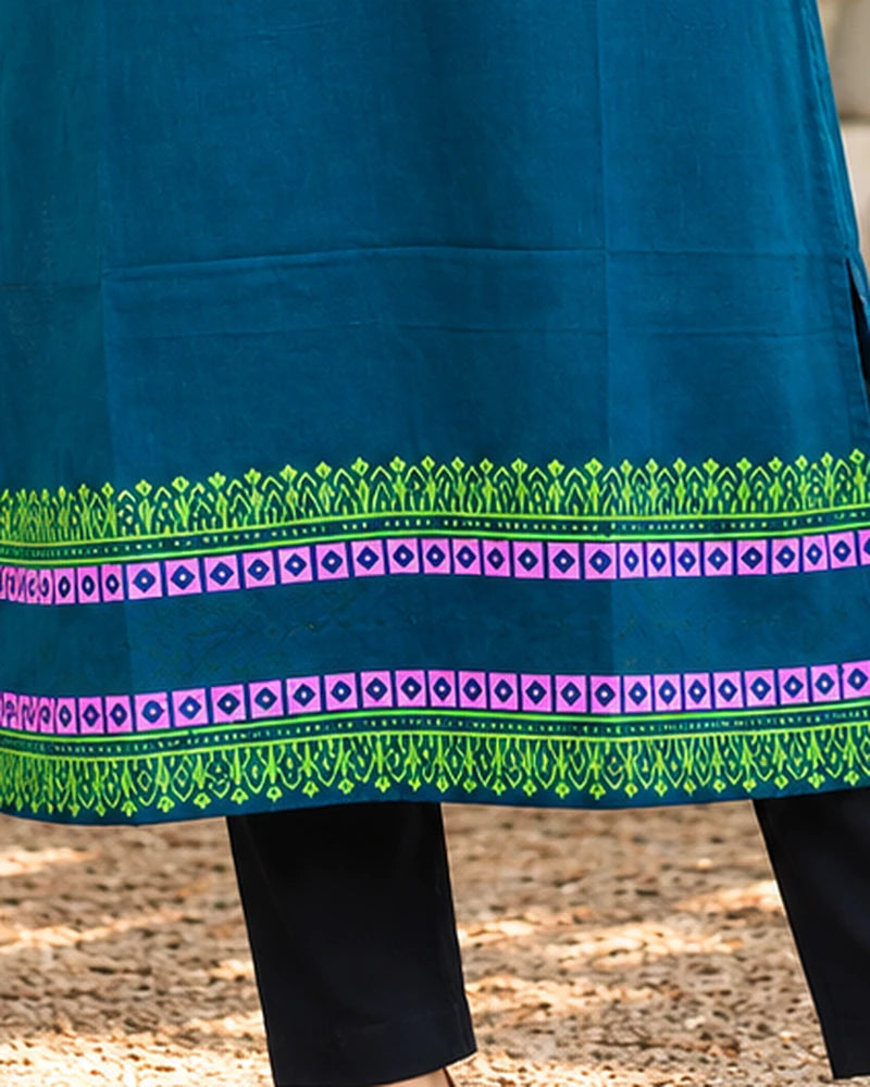 Close-up of green and magenta block print hem borders on teal cotton long kurta