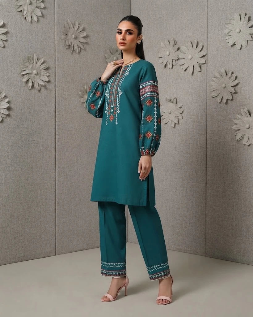 Woman wearing teal embroidered cotton two-piece set, side angle pose