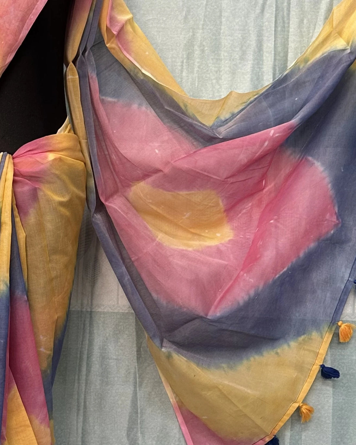 Close-up of tie-dye batik saree pallu with tassel border